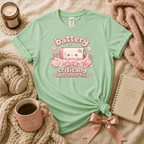 Battery introvert graphic t-shirt cozy flat lay in mint green.