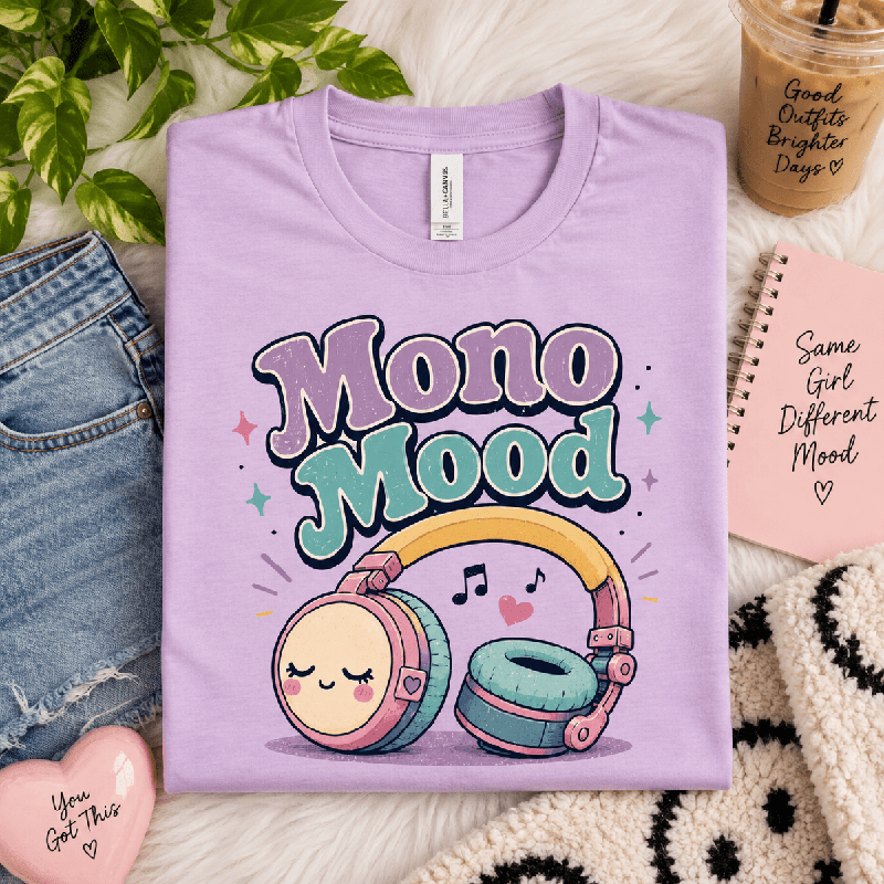 Mono Mood Premium T-Shirt in lilac, folded close-up styled with a notebook and iced coffee