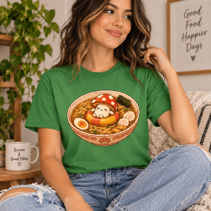 Woman wearing the Mushroom Float Premium T-Shirt in leaf green near a "Good Food Happier Days" sign