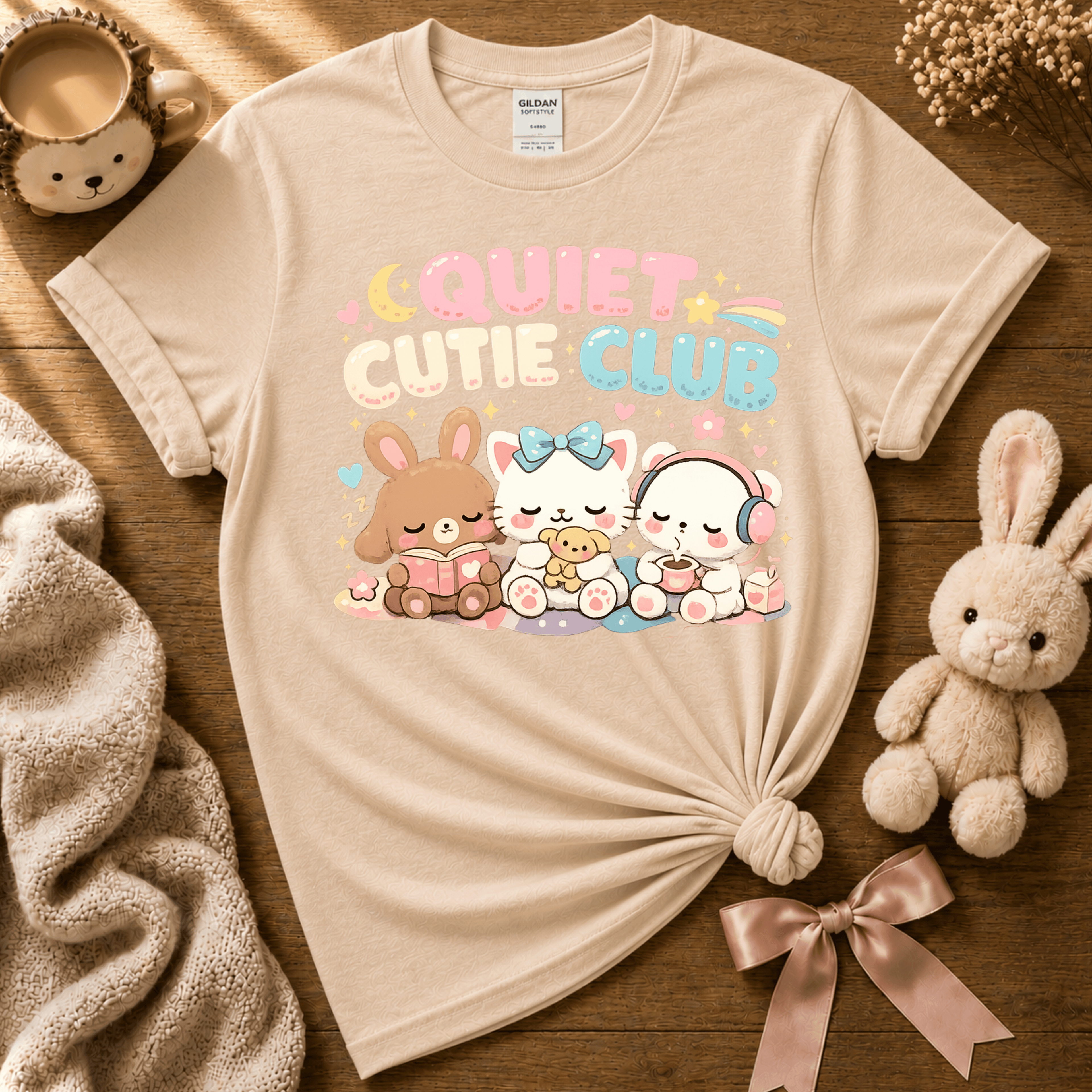 Quiet Cutie Club 2 cute animal graphic t-shirt cozy flat lay in natural.