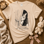 Observing introvert graphic t-shirt displayed in a cozy flat lay in natural.