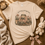 Saving Progress cute animal graphic t-shirt displayed in a cozy flat lay in natural.