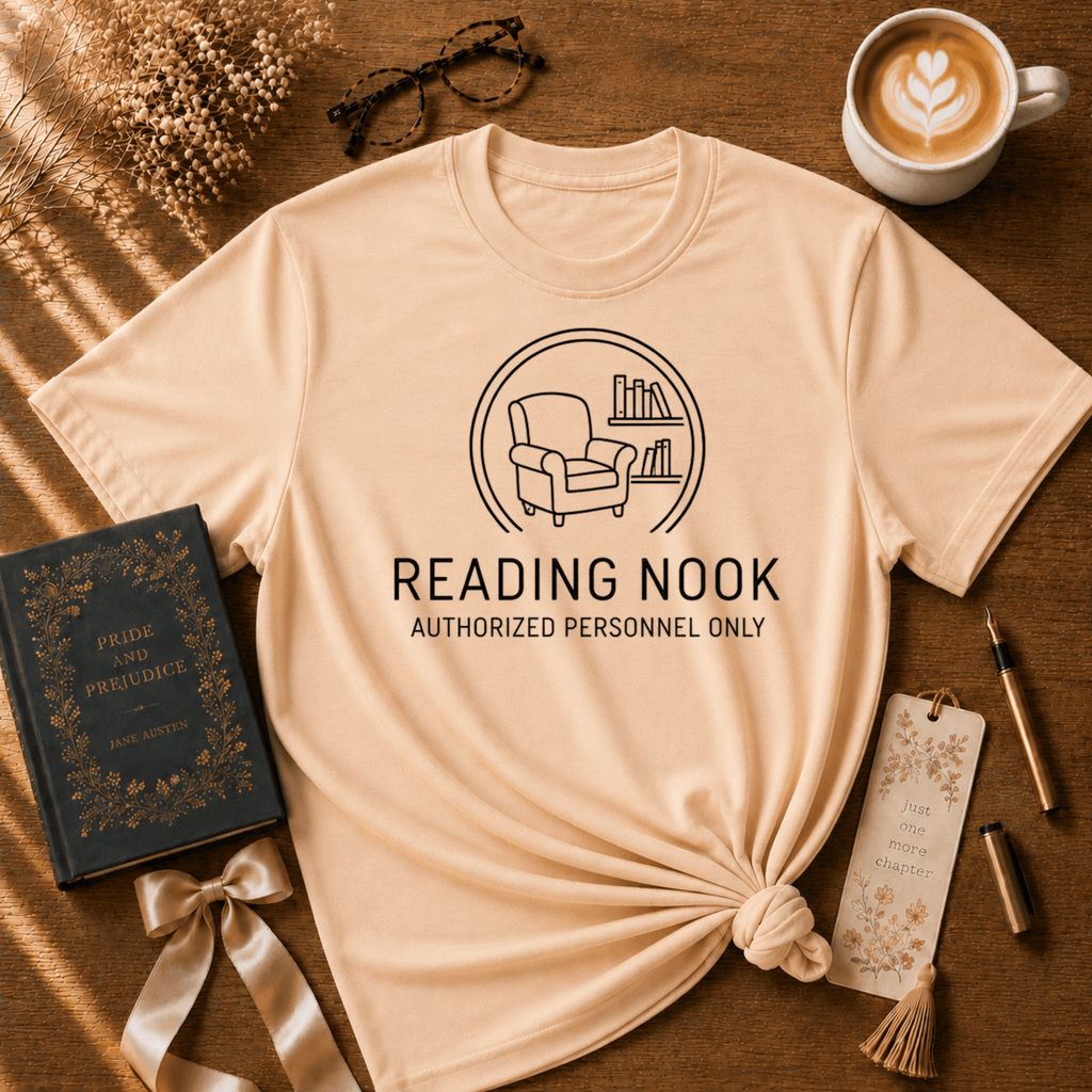 Reading Nook book graphic t-shirt displayed in a cozy flat lay in natural.