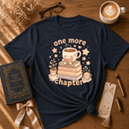 One More Chapter book lover graphic t-shirt displayed in a cozy flat lay in navy.
