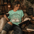 Woman reading a book and holding a mug, wearing the Nonfictiony Premium T-Shirt in mint