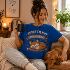 Woman sitting on a couch holding a mug, wearing the Not Available Premium T-Shirt in true royal blue