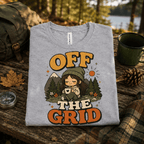 Off The Grid Nature Lover Premium T-Shirt in athletic heather gray, folded close-up outdoors with neck tag showing