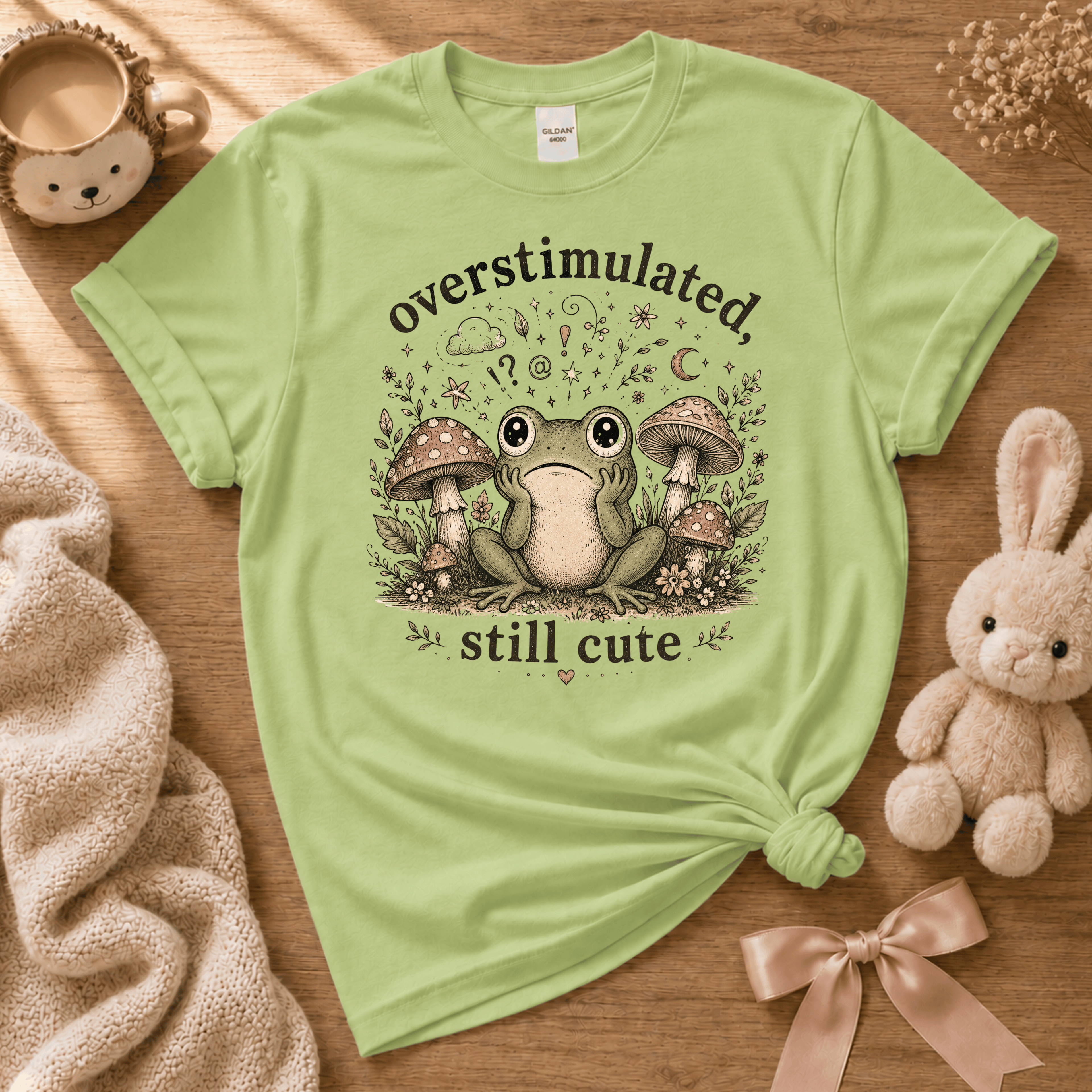 Overstimulated cute animal graphic t-shirt cozy flat lay in pistachio green.