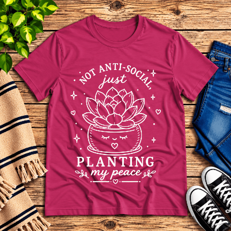 Planting My Peace Premium T-Shirt in berry, flat lay with kawaii potted succulent graphic