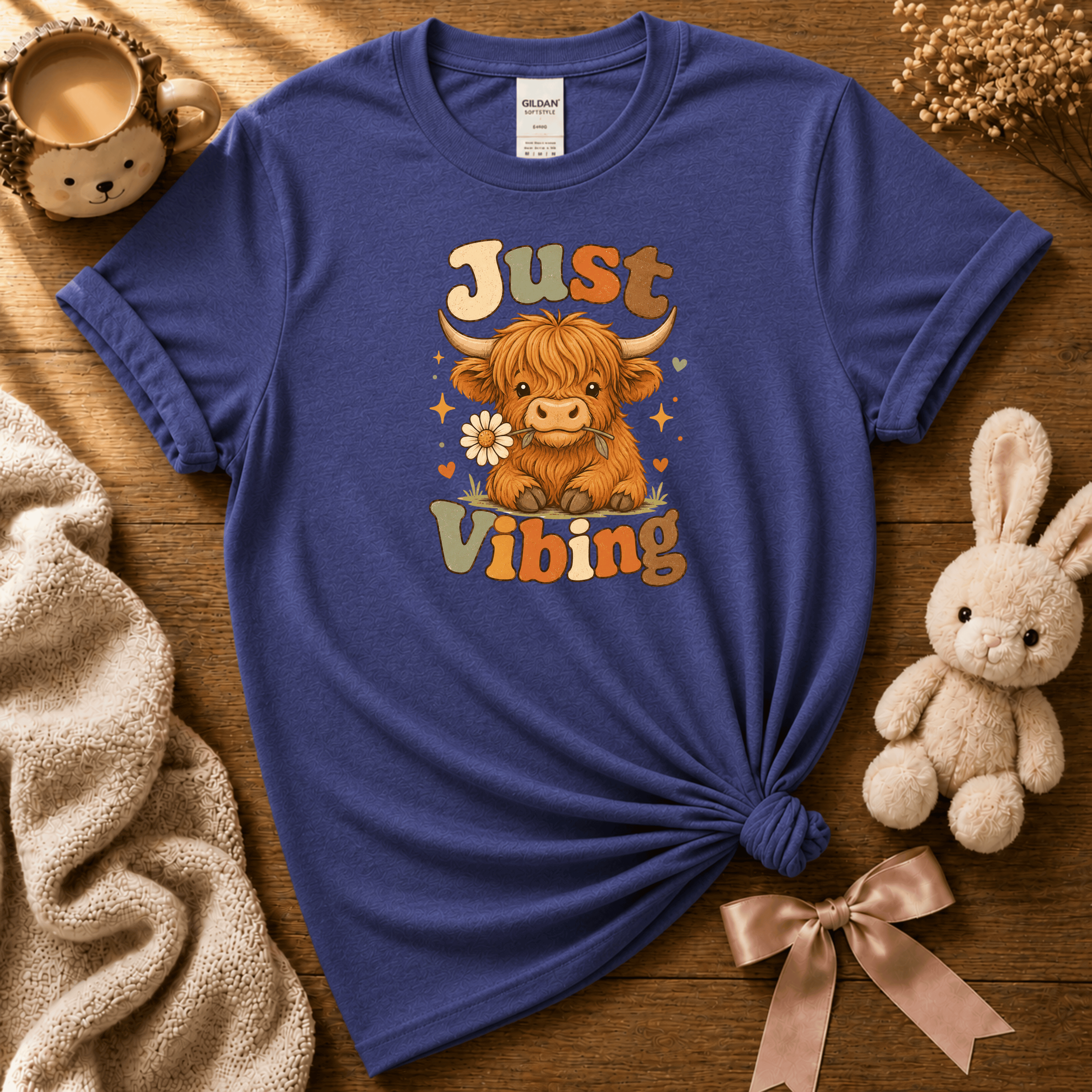 Just Vibing Cow cute animal graphic t-shirt cozy flat lay in purple.