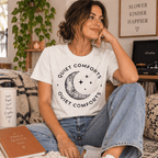 Woman sitting and wearing the Quiet Comforts Dark Premium T-Shirt in vintage white