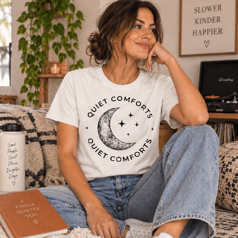 Woman sitting and wearing the Quiet Comforts Dark Premium T-Shirt in vintage white