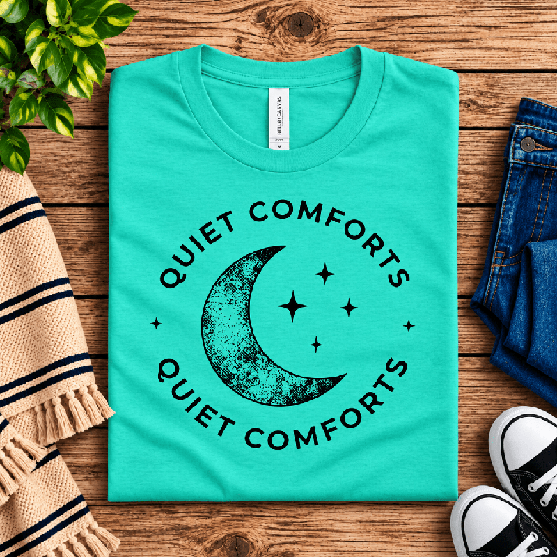 Quiet Comforts Dark Premium T-Shirt in heather sea green, folded close-up with neck tag showing