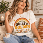 Woman sitting indoors, wearing the Quiet Is Golden Premium T-Shirt in vintage white
