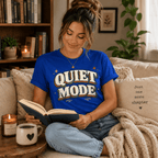 Woman reading a book on a couch, wearing the Quiet Mode Premium T-Shirt in true royal blue