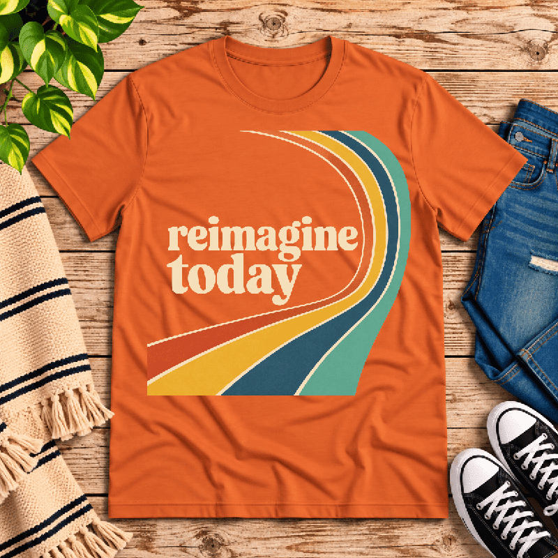 Reimagine Today Premium T-Shirt in burnt orange, flat lay with retro curved multicolor stripe graphic