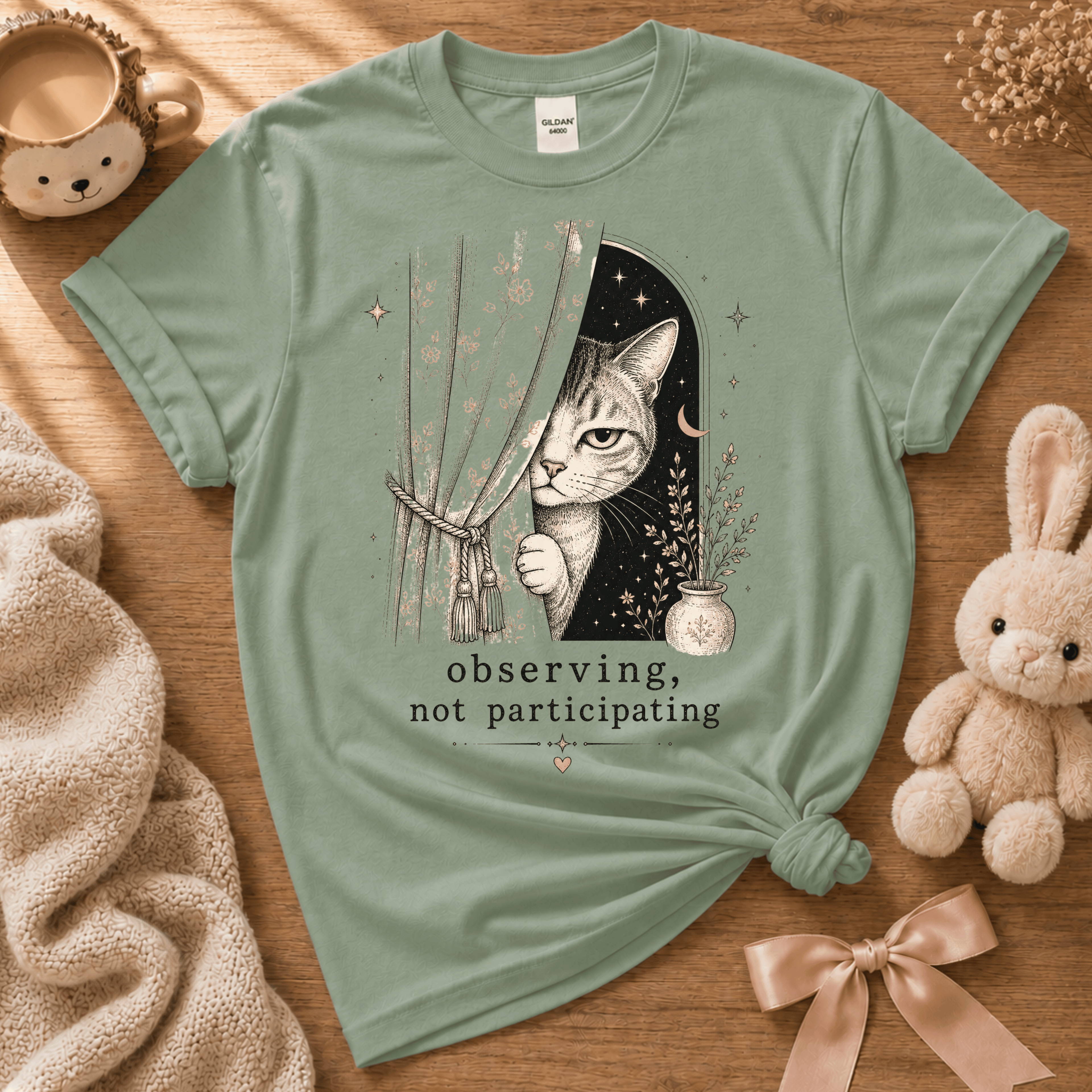 Observing cute animal graphic t-shirt cozy flat lay in sage.