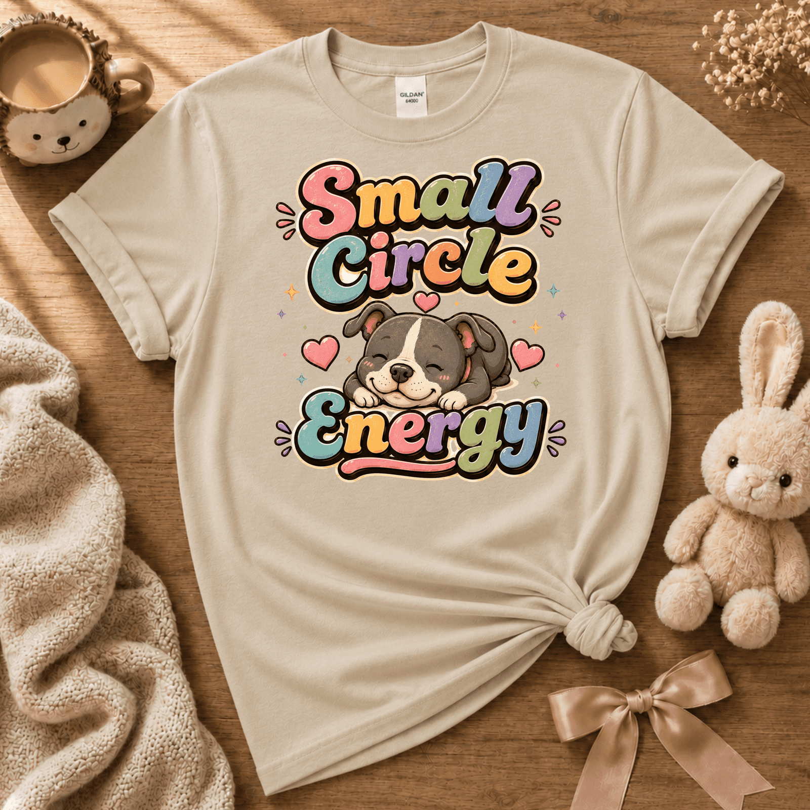 Small Circle Energy cute animal graphic t-shirt cozy flat lay in sand.