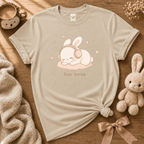 Low Noise cute animal graphic t-shirt cozy flat lay in sand.
