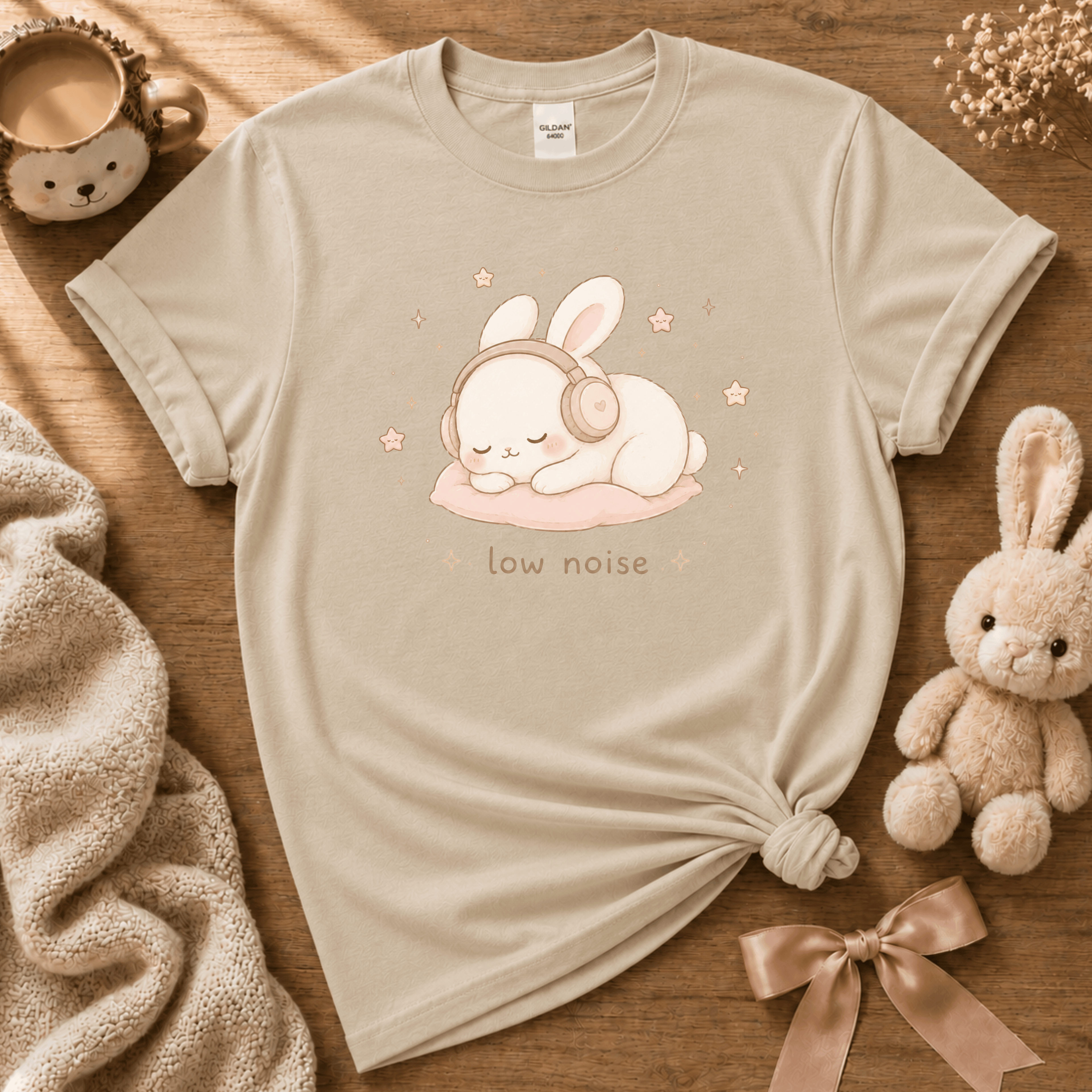 Low Noise cute animal graphic t-shirt cozy flat lay in sand.