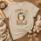 Personal Space Enthusiast cute animal graphic t-shirt displayed in a cozy flat lay in sand.