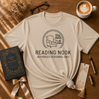 Reading Nook book lover graphic t-shirt cozy flat lay in sand.