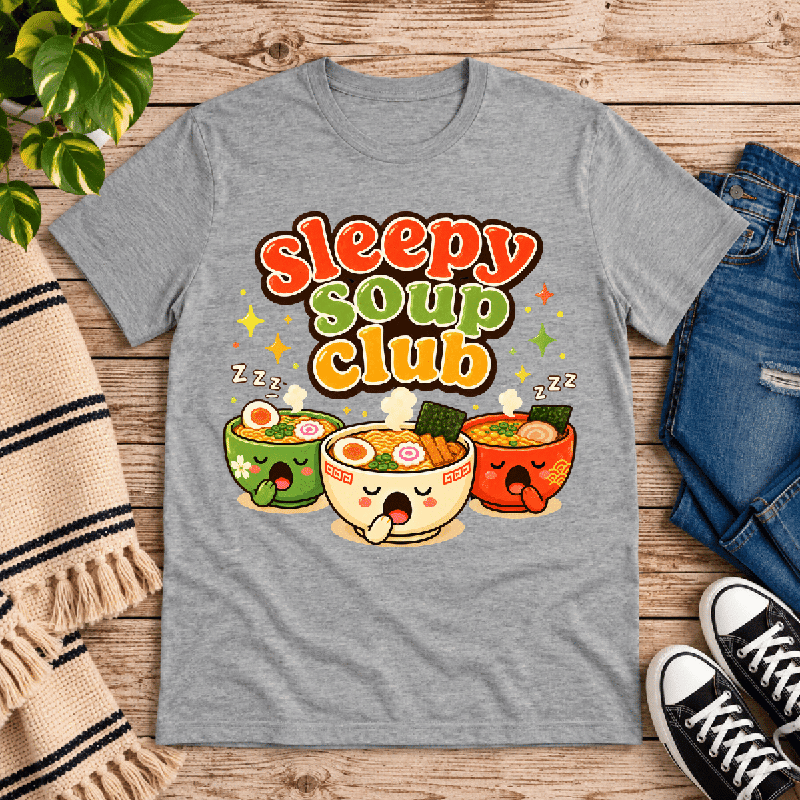 Sleepy Soup Club Premium T-Shirt in athletic heather gray, flat lay with three sleepy ramen bowl characters graphic