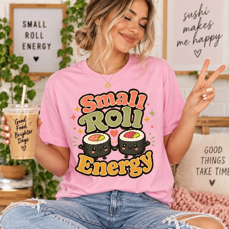 Woman holding an iced coffee, wearing the Small Roll Energy Premium T-Shirt in pink