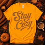 Stay Cozy Premium T-Shirt in gold, flat lay with autumn props