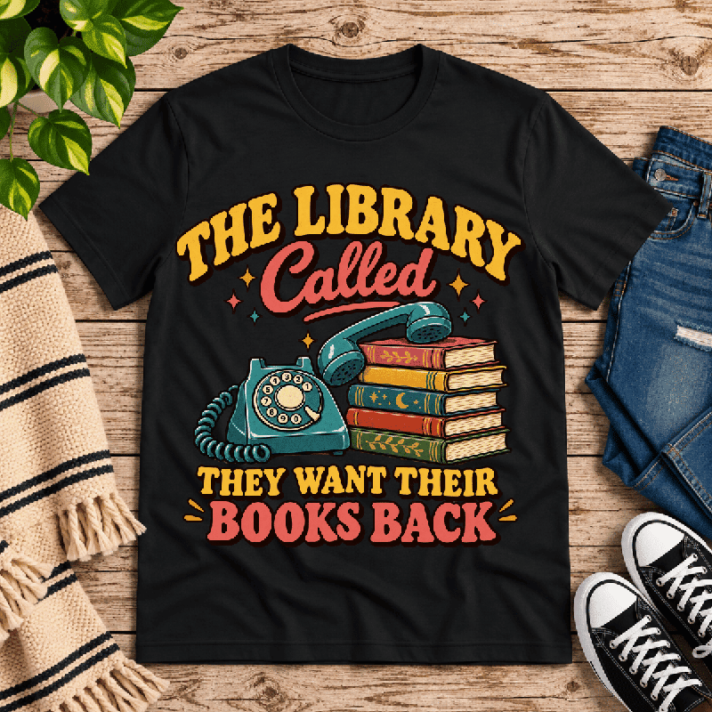 The Library Called Premium T-Shirt in vintage black, flat lay with retro rotary phone and books graphic