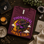Too Magical Premium T-Shirt in maroon, folded close-up styled with mystical props