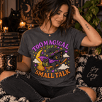 Woman seated among witchy decor, wearing the Too Magical Premium T-Shirt in asphalt gray