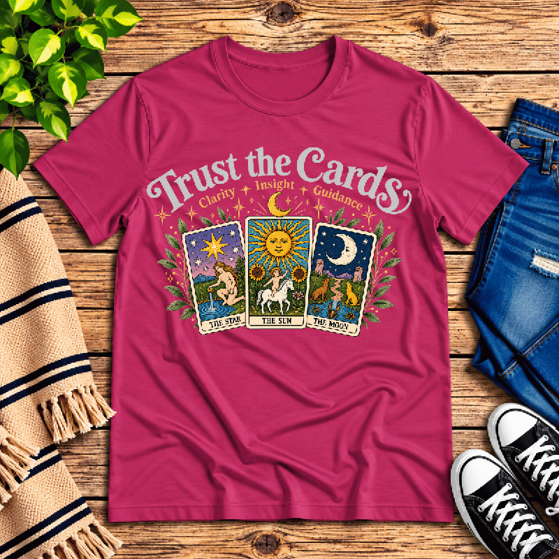 Trust The Cards Premium T-Shirt in berry, flat lay with Star, Sun, and Moon tarot card graphic