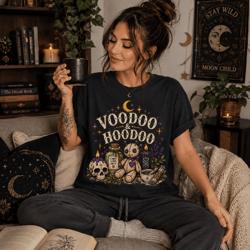 Woman holding a mug, wearing the Voodoo & Hoodoo Premium T-Shirt in vintage black