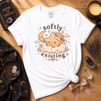 Softly Existing celestial graphic t-shirt cozy flat lay in white.
