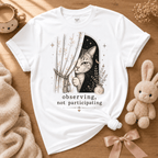 Observing cute animal graphic t-shirt displayed in a cozy flat lay in white.