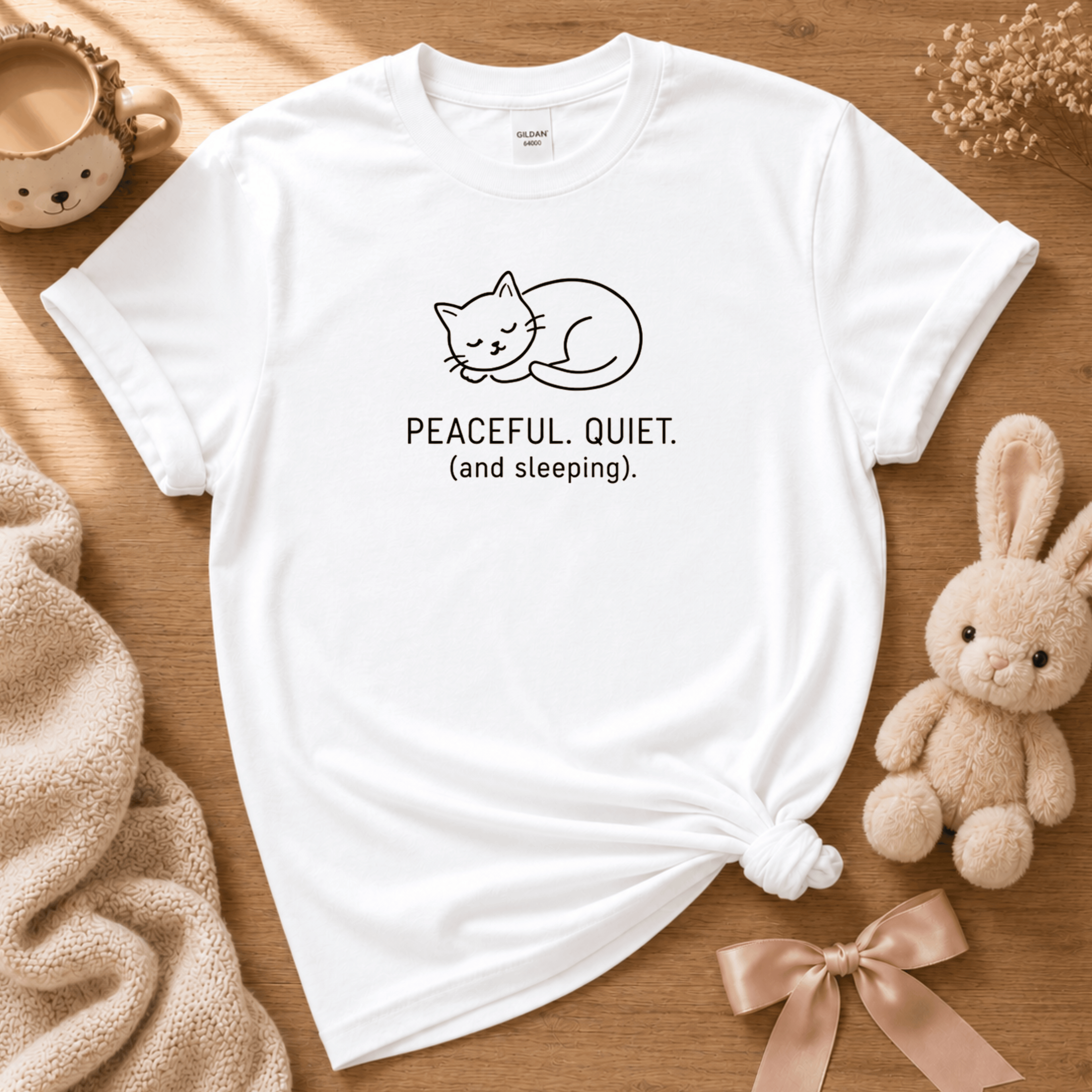 Peaceful, quiet cute animal graphic t-shirt cozy flat lay in white.