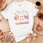 Eggsistential Kawaii graphic t-shirt cozy flat lay in white.